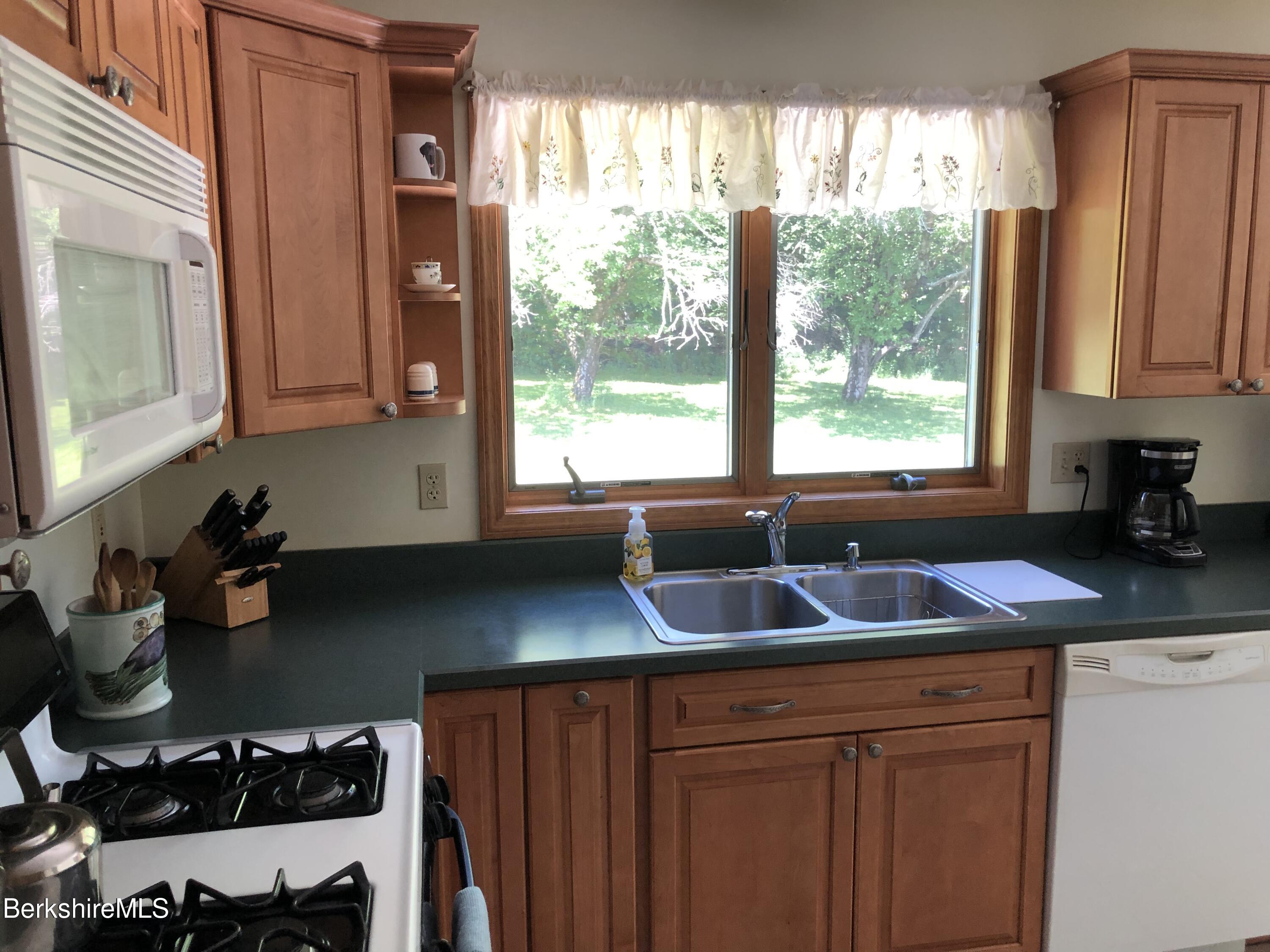 1387 East Windsor Road Windsor, MA 01270 - Photo 10 of 38 a kitchen with stainless steel appliances a sink a stove a window and cabinets