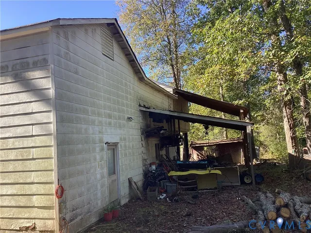 a view of a chair and table in backyard of the house
