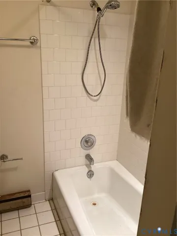 a bathroom with a sink a window and a shower