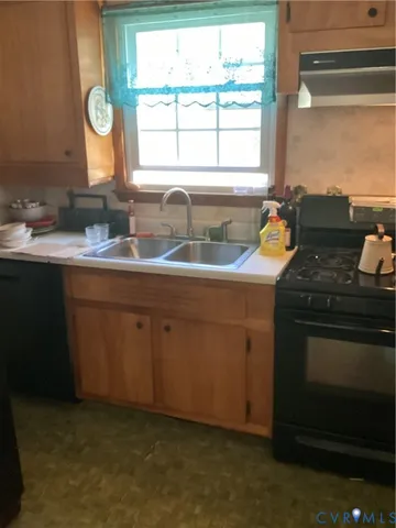 a kitchen with a sink stove and cabinets