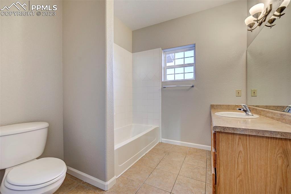 5433 Prominence Point Colorado Springs, CO 80923 - Photo 14 of 26 a bathroom with a sink a toilet and tub