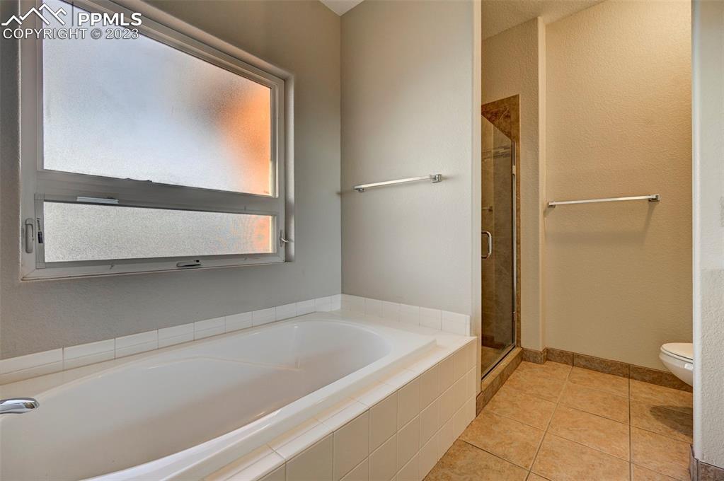 5433 Prominence Point Colorado Springs, CO 80923 - Photo 23 of 26 a bathroom with a bathtub and a shower