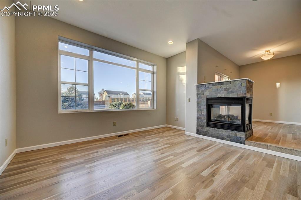 5433 Prominence Point Colorado Springs, CO 80923 - Photo 3 of 26 a view of an empty room with a window and fireplace