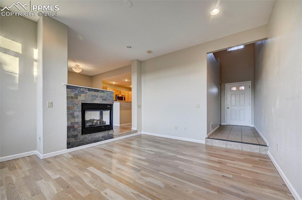 5433 Prominence Point Colorado Springs, CO 80923 - Photo 4 of 26 a view of an empty room with a fireplace and a window