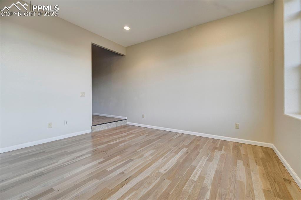 5433 Prominence Point Colorado Springs, CO 80923 - Photo 5 of 26 a view of an empty room with wooden floor