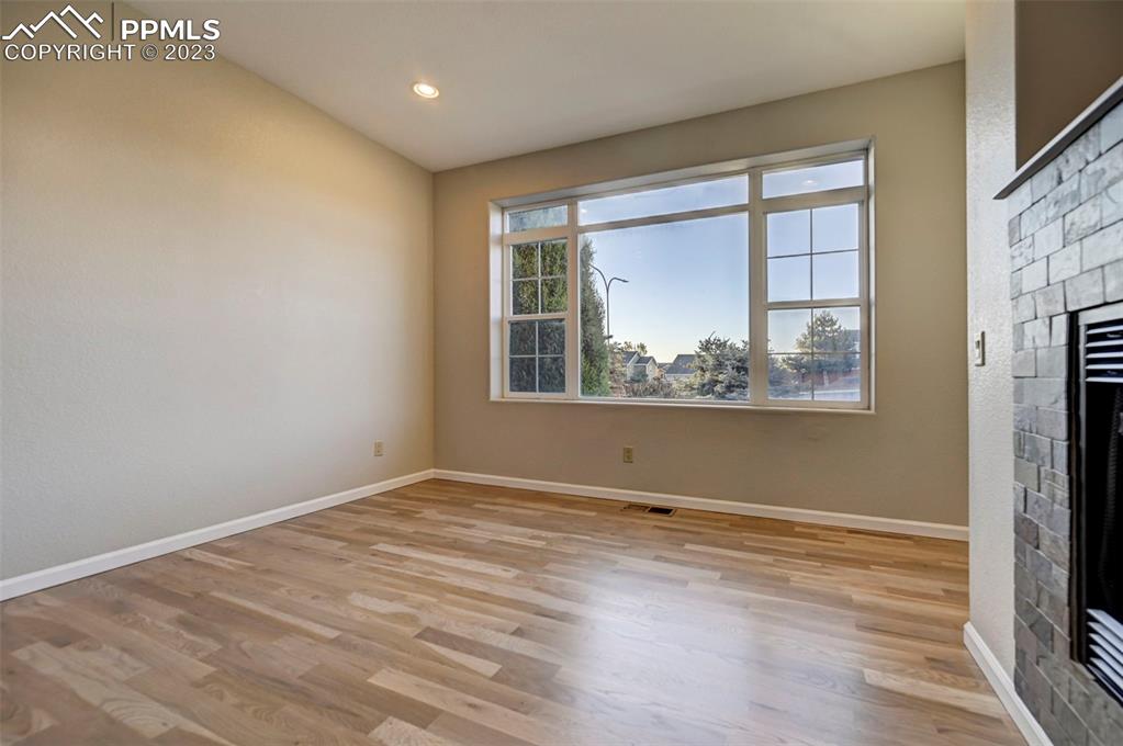 5433 Prominence Point Colorado Springs, CO 80923 - Photo 6 of 26 an empty room with wooden floor and windows