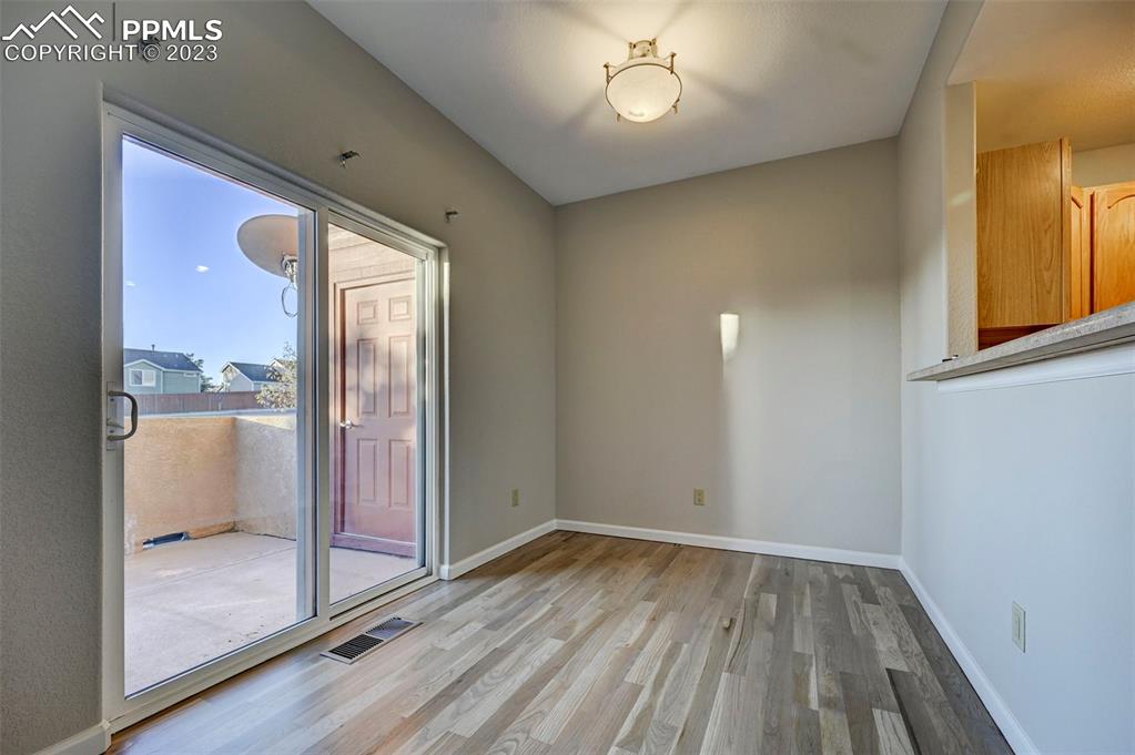 5433 Prominence Point Colorado Springs, CO 80923 - Photo 7 of 26 a view of empty room with wooden floor