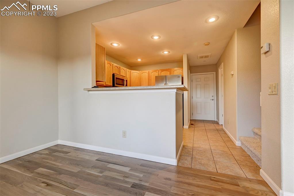 5433 Prominence Point Colorado Springs, CO 80923 - Photo 8 of 26 a view of a hallway with wooden floor