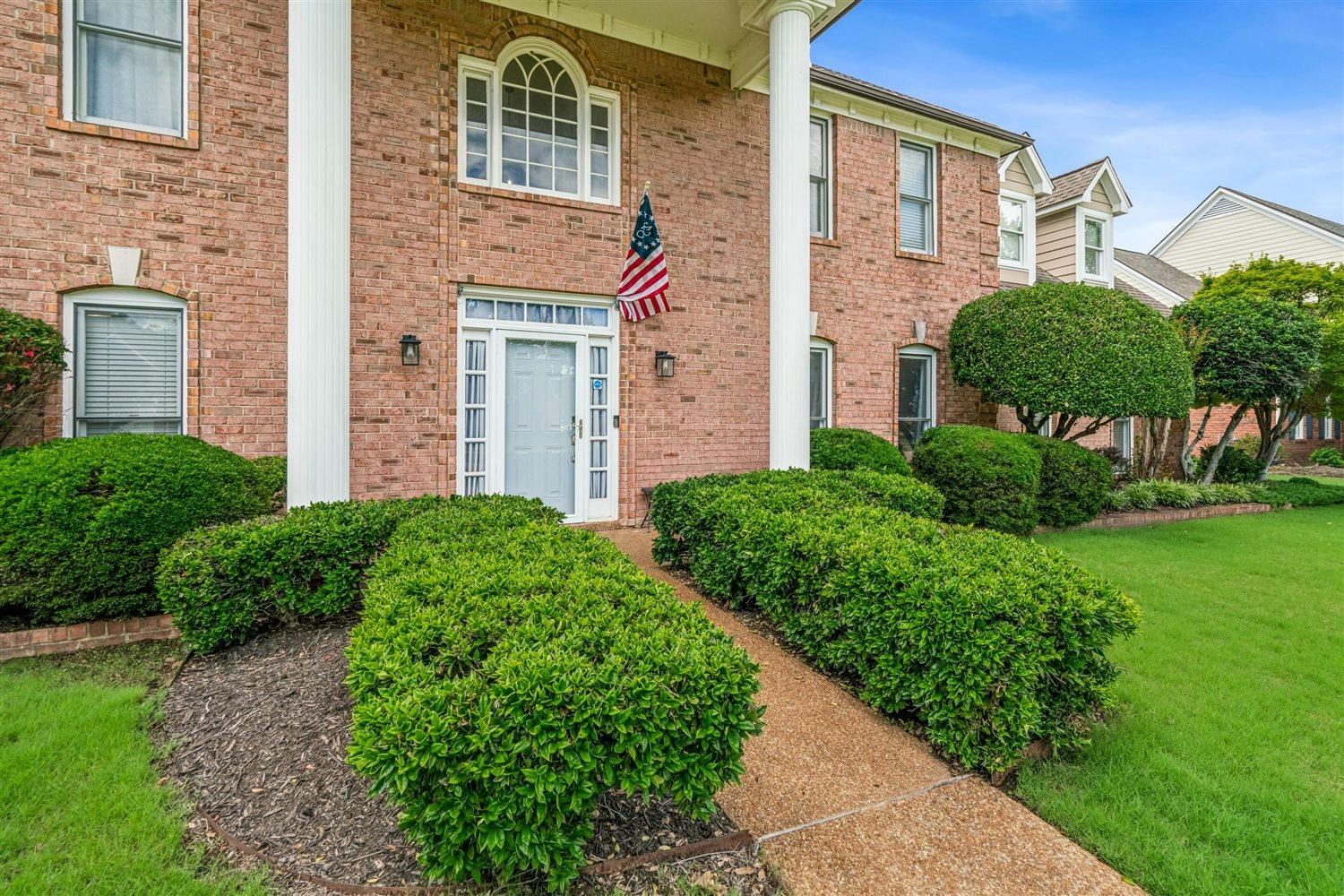 1489 John Ridge Drive Collierville, TN 38017 - Photo 3 of 39 a front view of a house with garden