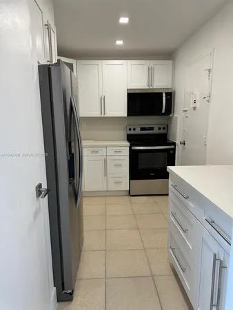 a kitchen with stainless steel appliances a refrigerator a stove a microwave and cabinets