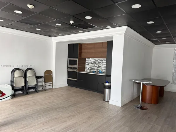 a room with furniture a flat screen tv and a table