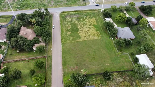 an aerial view of residential house with outdoor space and a lake view