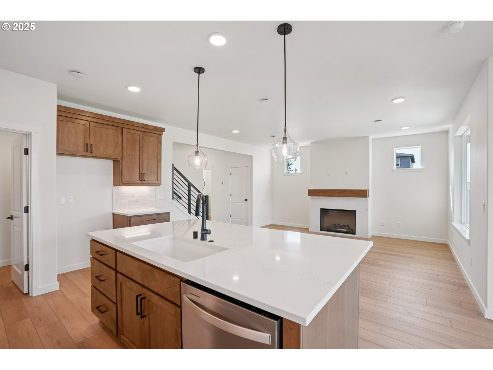 1101 North 44th Place Ridgefield, WA 98642 - Photo 9 of 48 a kitchen with a sink chandelier and a fireplace