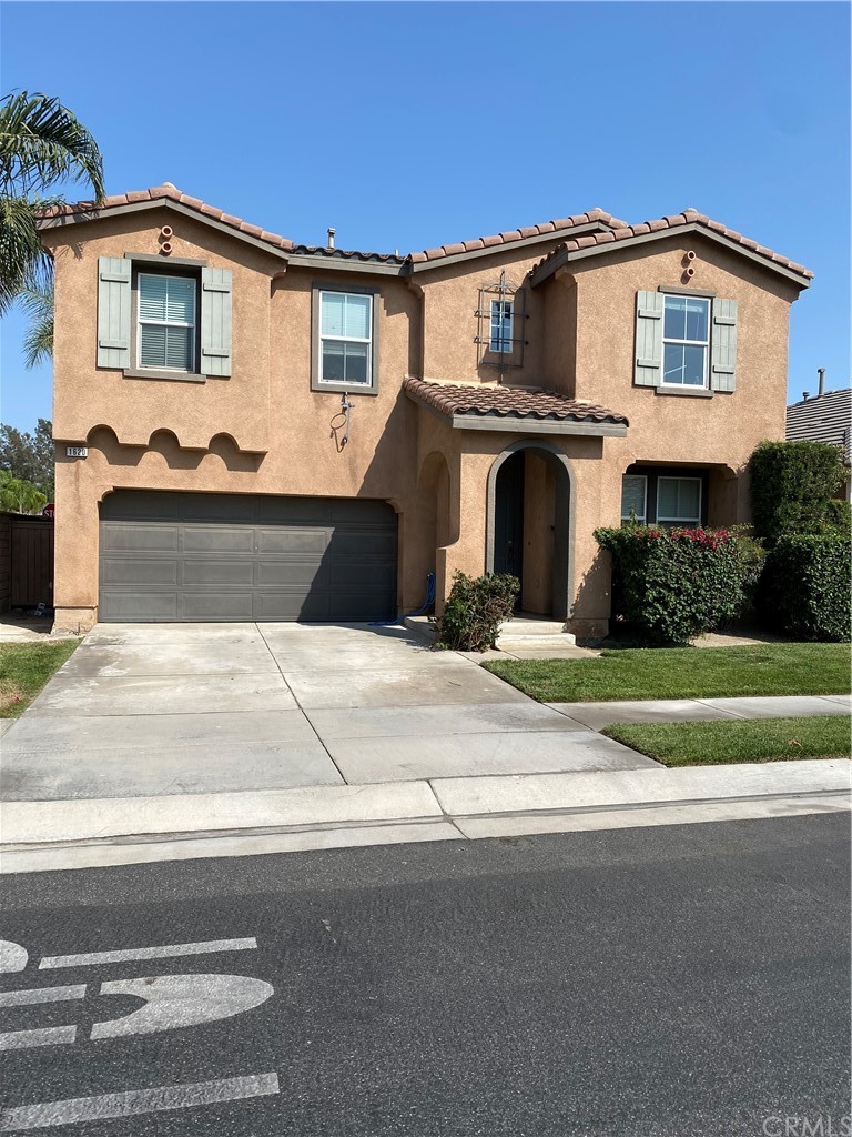 1620 Edmon Way Riverside, CA 92501 - Photo 1 of 1 a front view of a house with a yard and garage