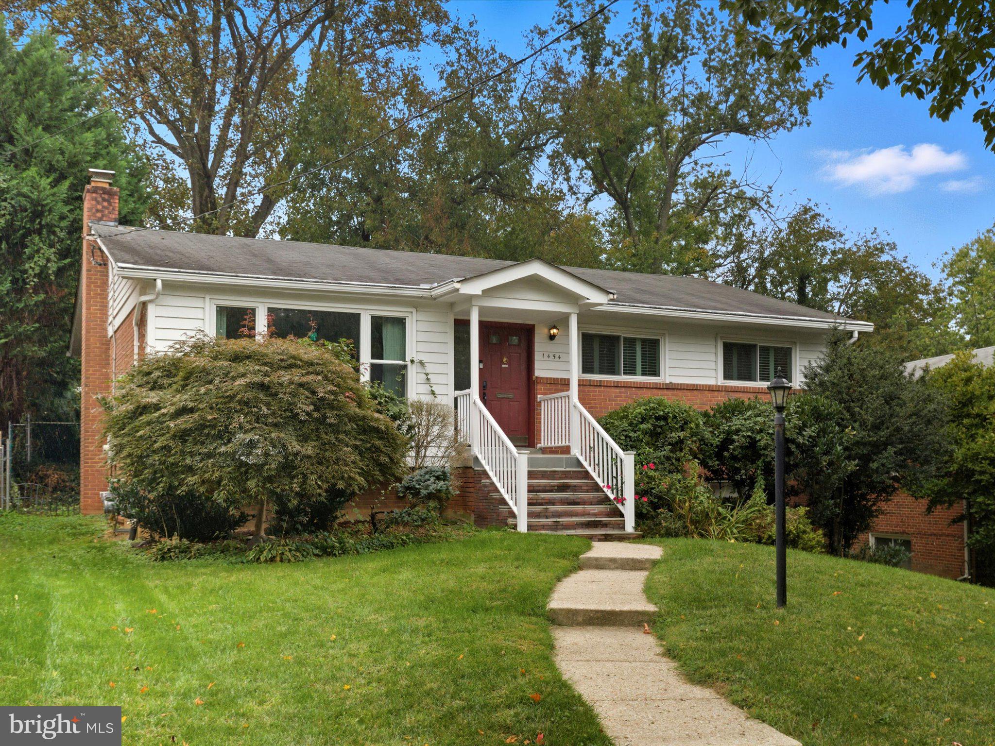 a front view of house with yard and green space