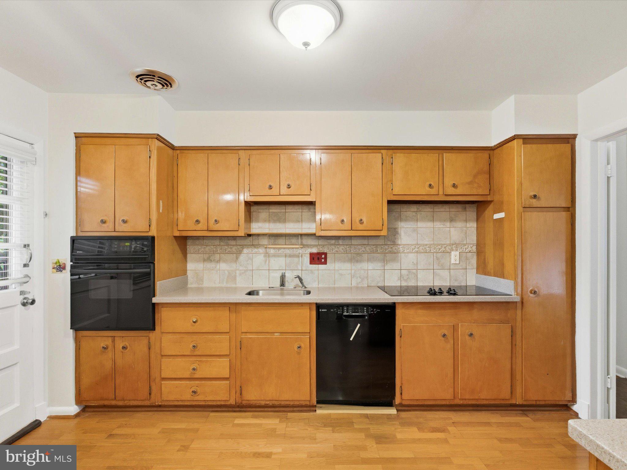 1454 Roxanna Road Northwest Washington, DC 20012 - Photo 13 of 48 a kitchen with stainless steel appliances granite countertop a sink a stove and a refrigerator