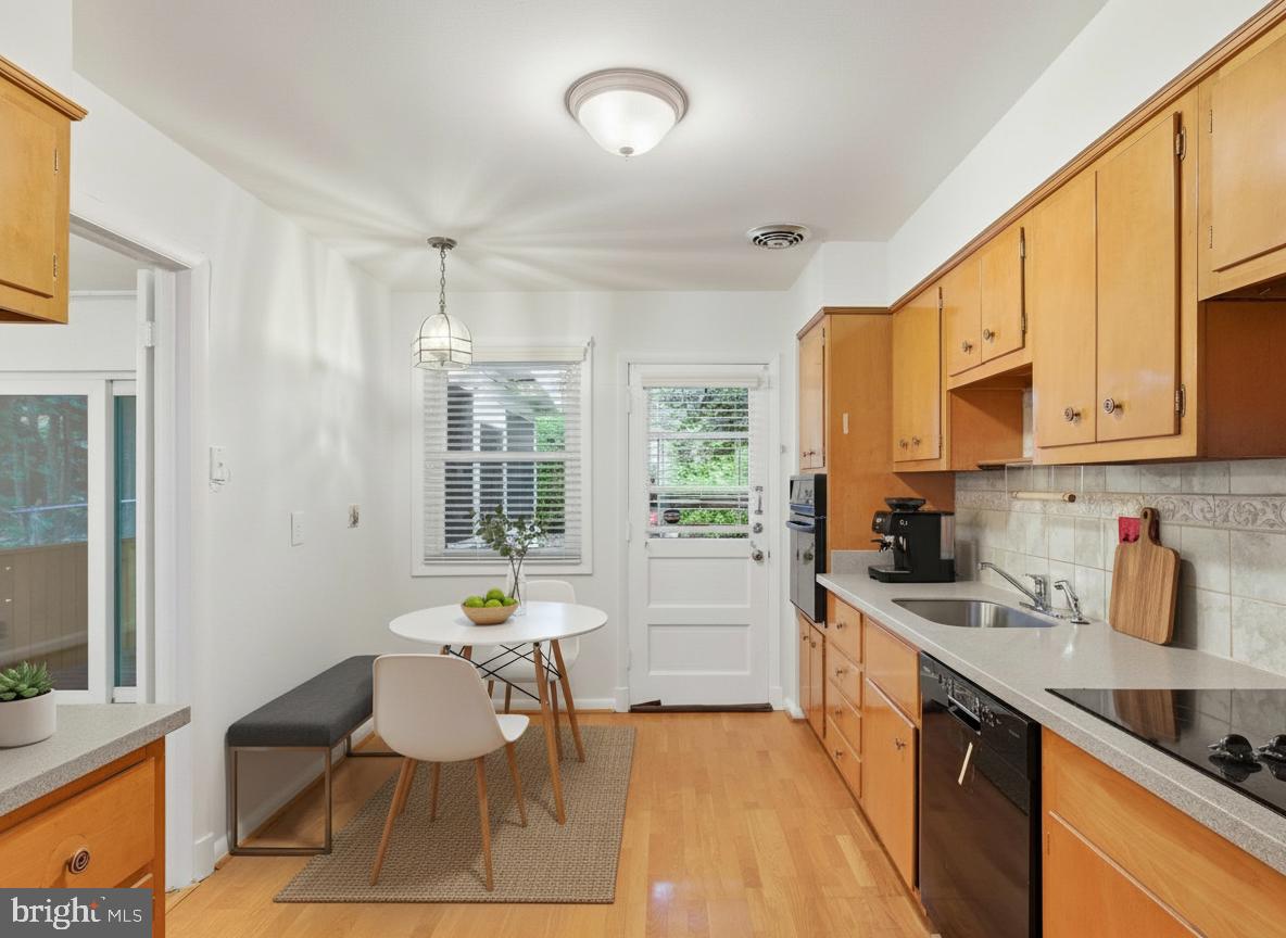 1454 Roxanna Road Northwest Washington, DC 20012 - Photo 15 of 48 a kitchen with stainless steel appliances kitchen island granite countertop a sink and cabinets