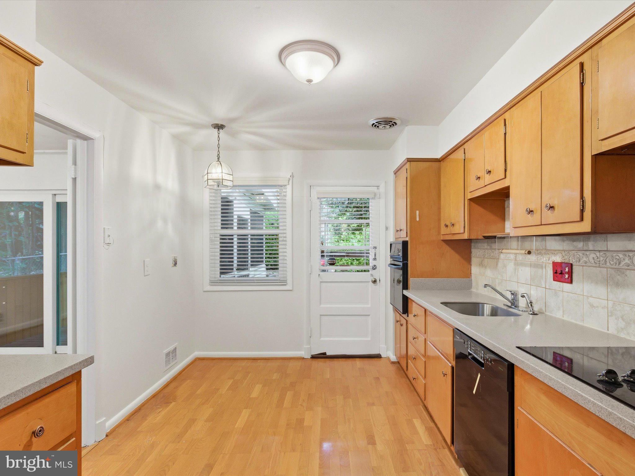 1454 Roxanna Road Northwest Washington, DC 20012 - Photo 16 of 48 a kitchen with stainless steel appliances granite countertop a sink stove and refrigerator