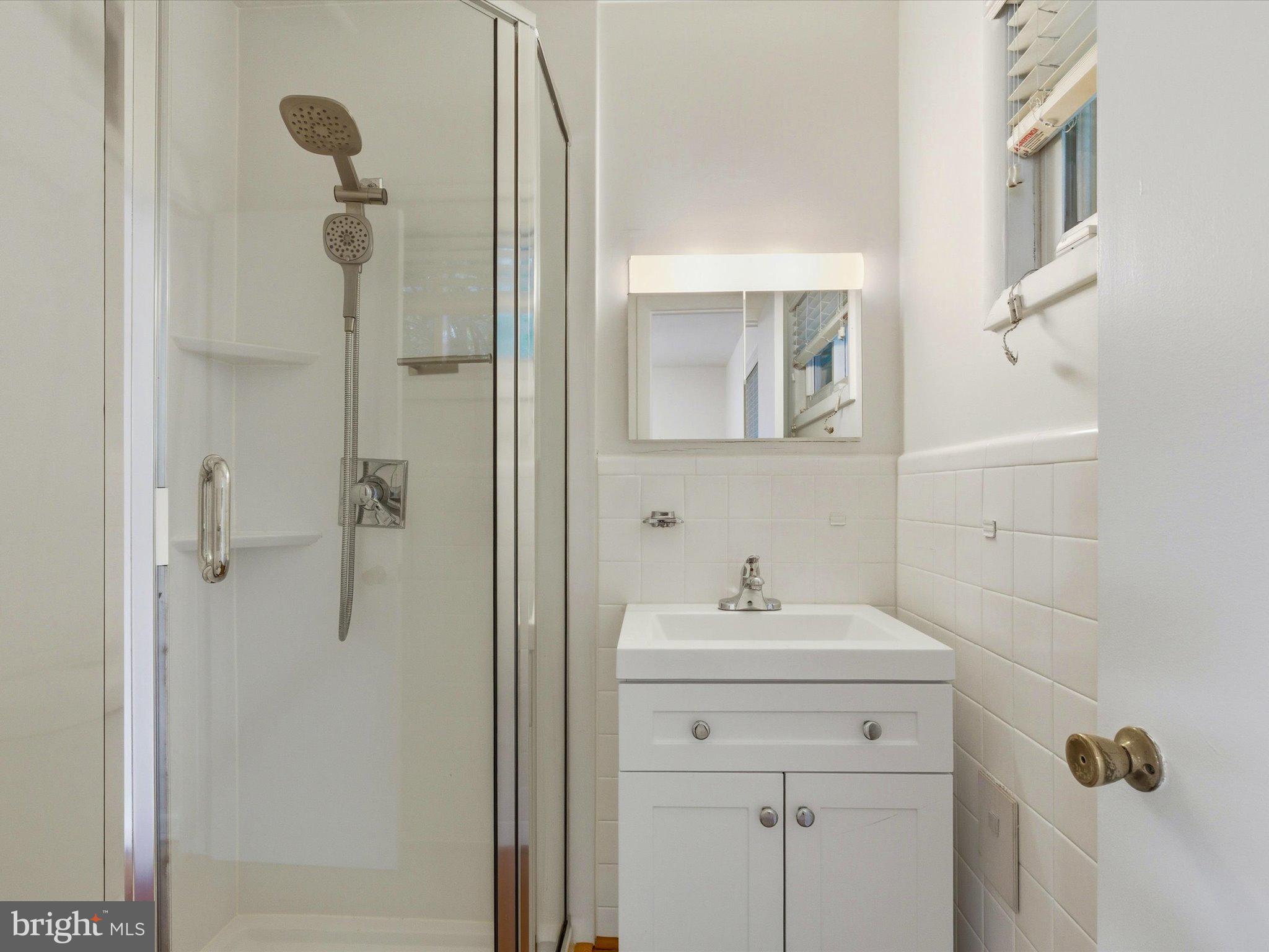 1454 Roxanna Road Northwest Washington, DC 20012 - Photo 20 of 48 a bathroom with a sink vanity and shower