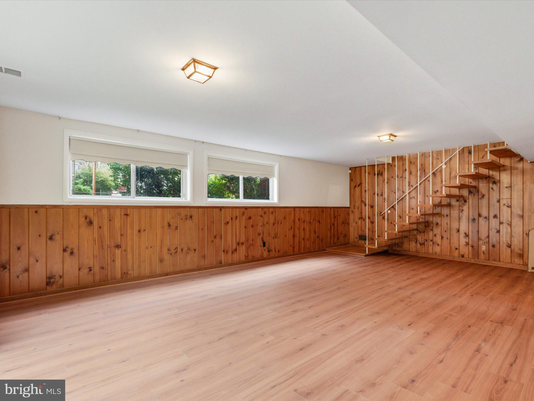 1454 Roxanna Road Northwest Washington, DC 20012 - Photo 30 of 48 an empty room with wooden floor and windows
