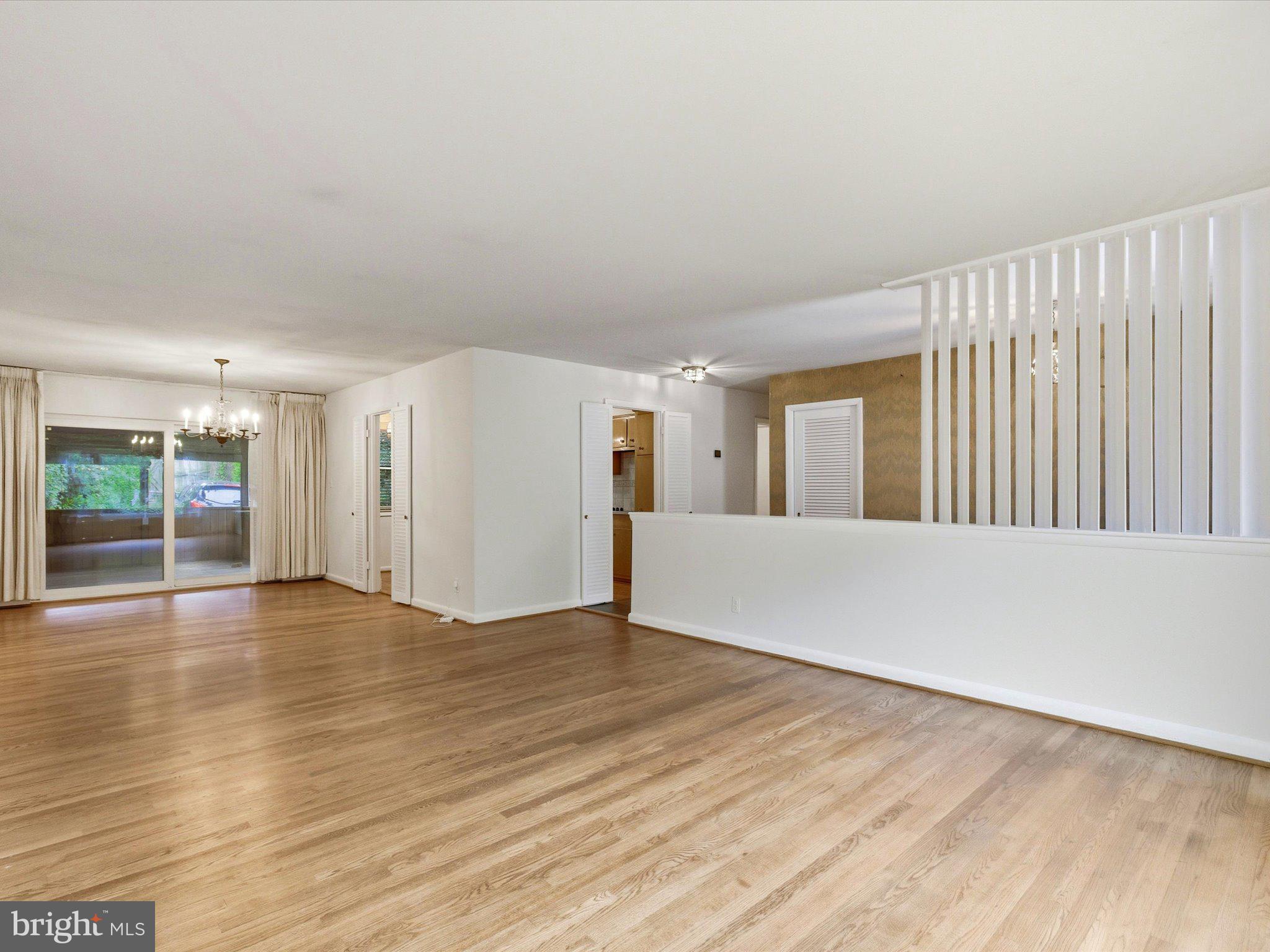1454 Roxanna Road Northwest Washington, DC 20012 - Photo 8 of 48 a view of an empty room with wooden floor and a window