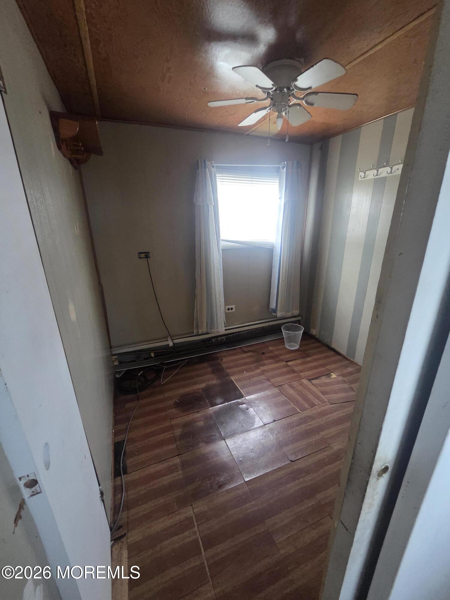 45 Locust Grove Hazlet, NJ 07730 - Photo 14 of 14 a view of a livingroom with a ceiling fan and window