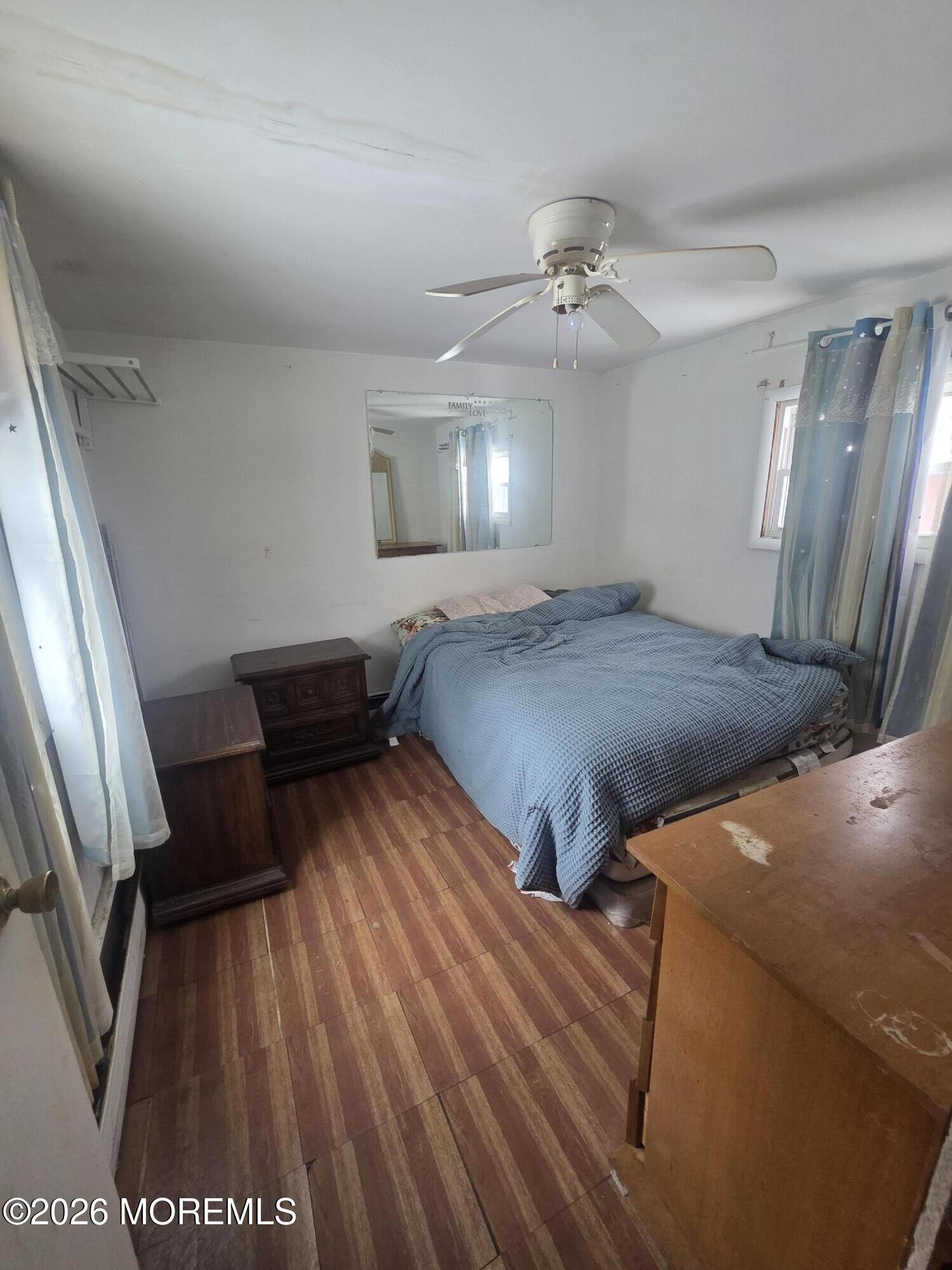 45 Locust Grove Hazlet, NJ 07730 - Photo 9 of 14 a bedroom with a bed and a dresser with wooden floor