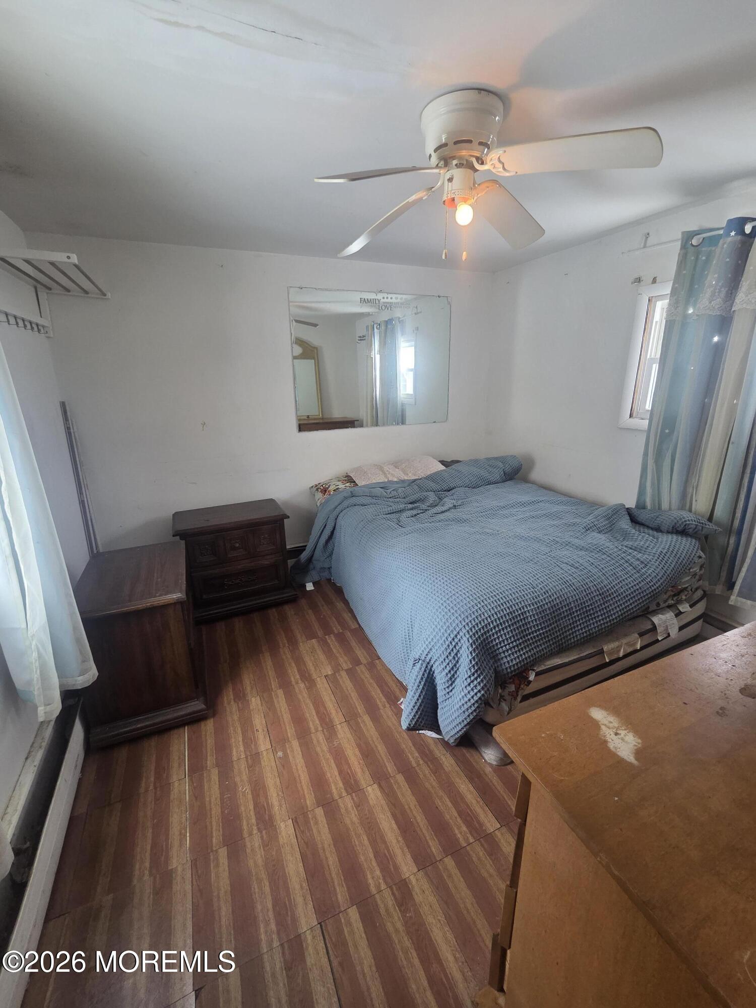 45 Locust Grove Hazlet, NJ 07730 - Photo 10 of 14 a bedroom with a bed and a chandelier