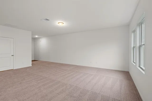 a kitchen with cabinets stainless steel appliances and wooden floor