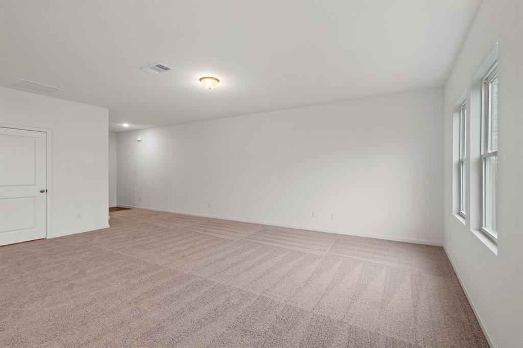 619 Colgate Circle Princeton, TX 75407 - Photo 11 of 31 wooden floor in an empty room with a window