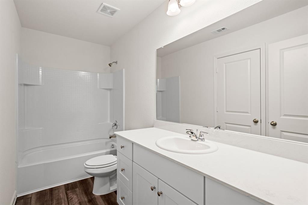 619 Colgate Circle Princeton, TX 75407 - Photo 23 of 31 a bathroom with a sink toilet and shower