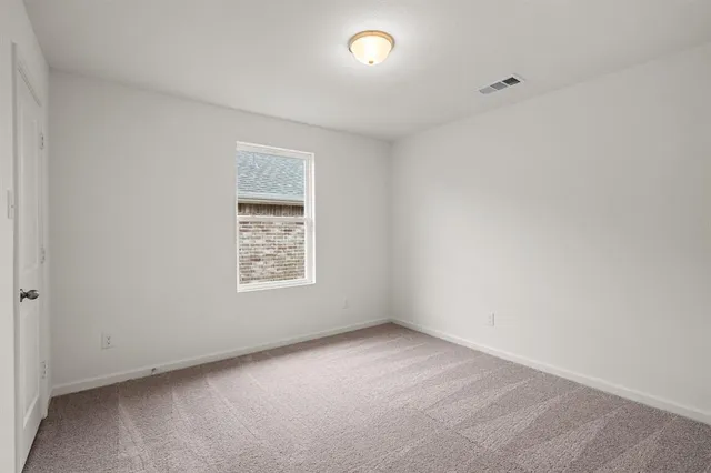 a bathroom with a sink a toilet a shower and a window