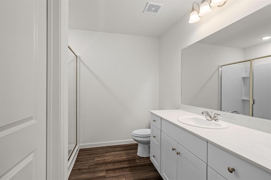 619 Colgate Circle Princeton, TX 75407 - Photo 29 of 31 a bathroom with a sink a toilet a shower and a window