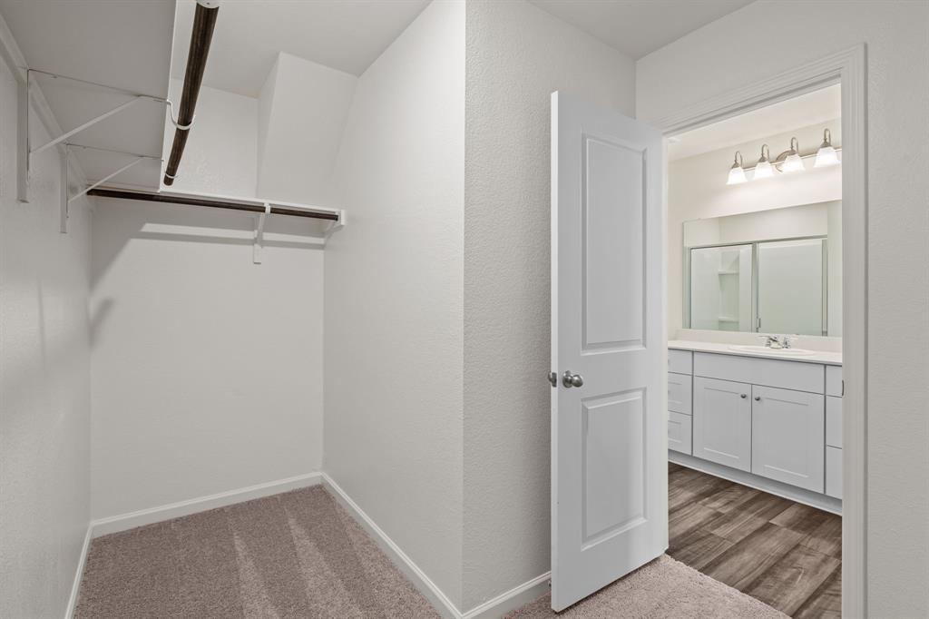 619 Colgate Circle Princeton, TX 75407 - Photo 30 of 31 a bathroom with a shower sink and mirror