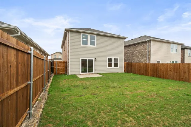a view of empty room with kitchen and window