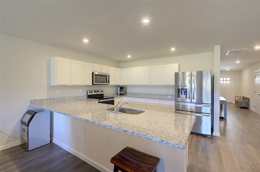 408 Chadwick Lane Walhalla, SC 29691 - Photo 8 of 44 Bright and open, this modern kitchen features an expansive island with granite countertops, perfect for culinary adventures.