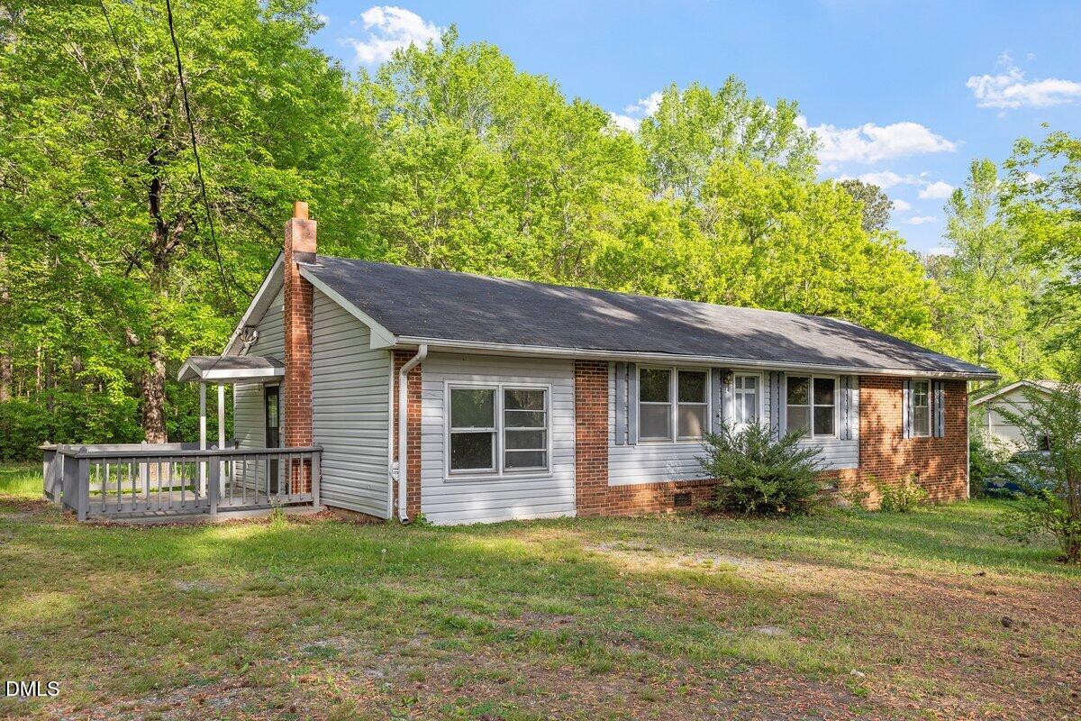 122 Richmond Road Mebane, NC 27302 - Photo 2 of 17 a view of a house with yard and a garden