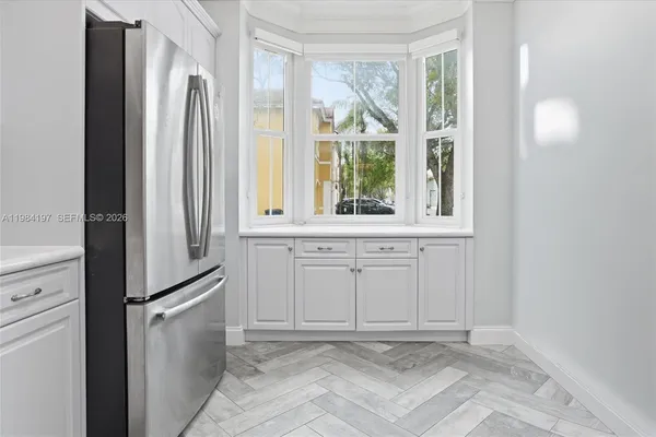 a view of a kitchen with dishwasher and a refrigerator
