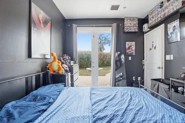 a bed room with a bed and a chandelier