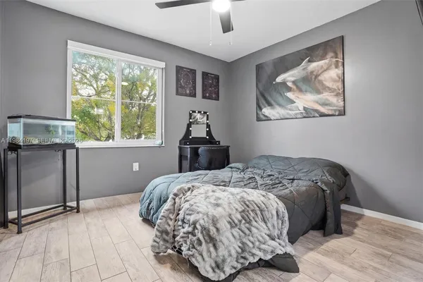 a bedroom with a bed and a painting on the wall