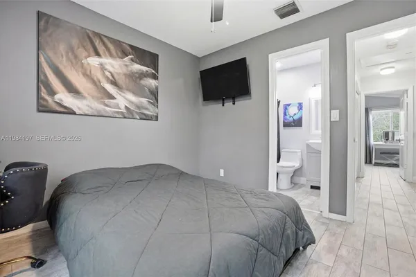 a bedroom with a bed and a flat screen tv