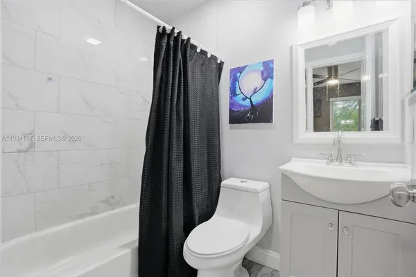 a bathroom with a toilet a sink and a bathtub