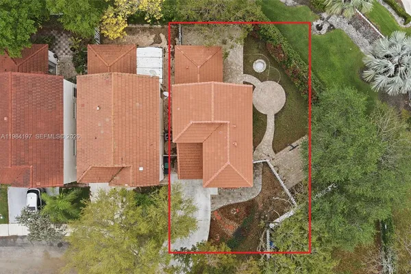 an aerial view of a house with a yard and plants