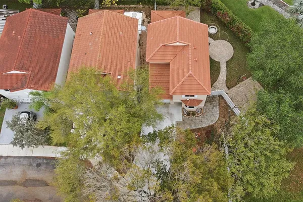 an aerial view of a house with a yard basket ball court and outdoor seating