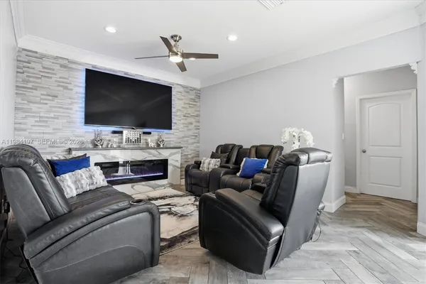 a living room with furniture a flat screen tv and a fireplace