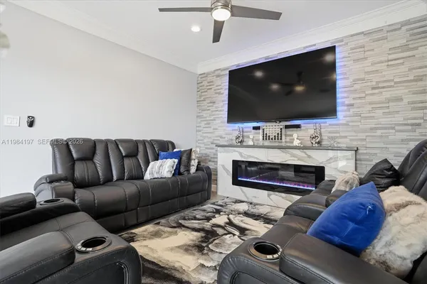a living room with furniture a flat screen tv and a fireplace