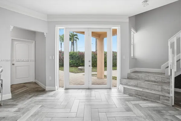 a view of an entryway with wooden floor and windows