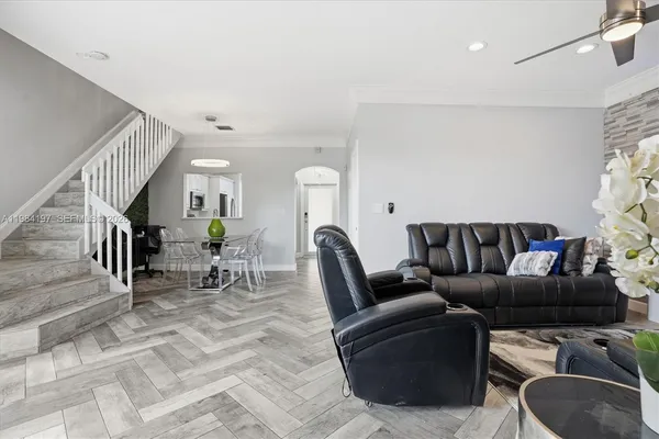 a living room with furniture a rug and a chandelier