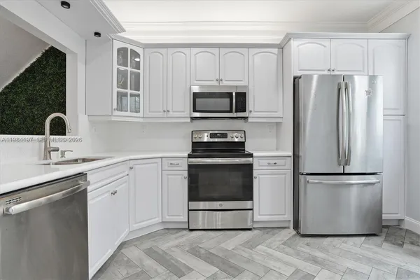 a kitchen with a refrigerator stove and sink