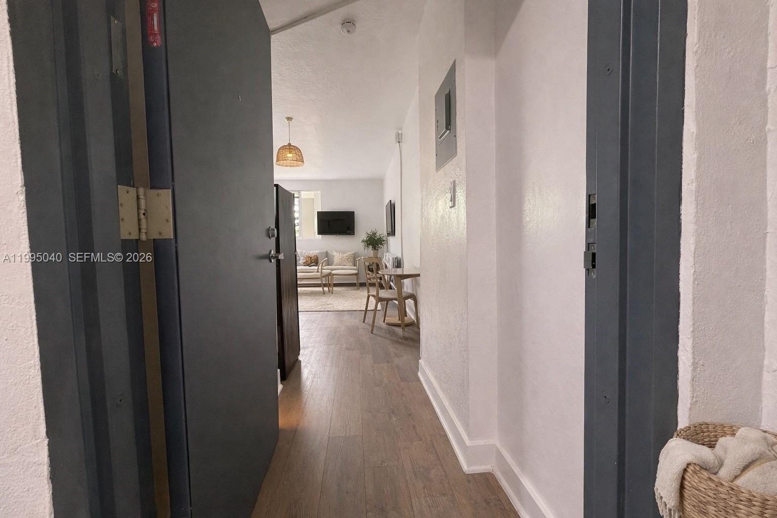 143 Southwest 9th Street, Unit 310 Miami, FL 33130 - Photo 12 of 20 a view of hallway with livingroom and wooden floor